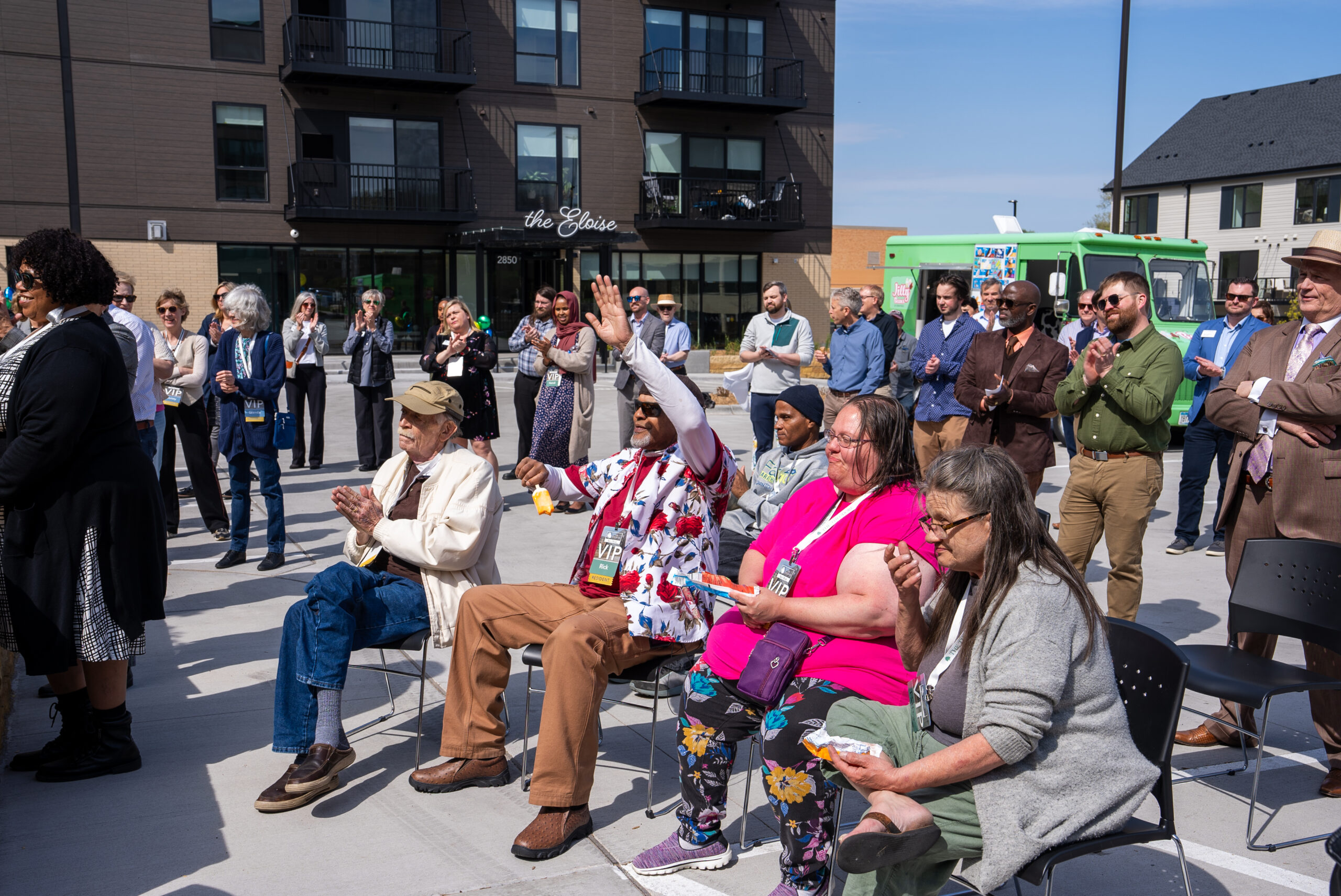 A crowd of residents and community members gathers at Wirth on the Woods