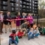Minneapolis Public Schools Superintendent and Wirth on the Woods project partners cut a ribbon to open a stormwater pond and outdoor learning classroom.