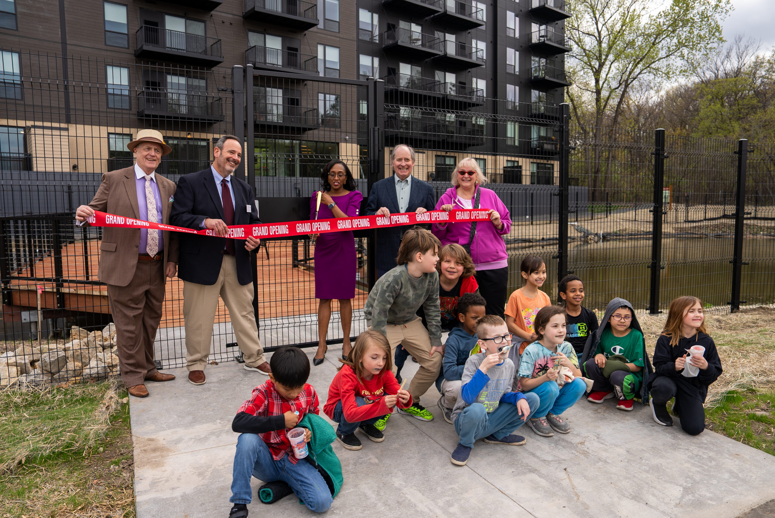 Minneapolis Public Schools Superintendent and Wirth on the Woods project partners cut a ribbon to open a stormwater pond and outdoor learning classroom.